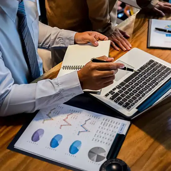 Working with data charts and a laptop