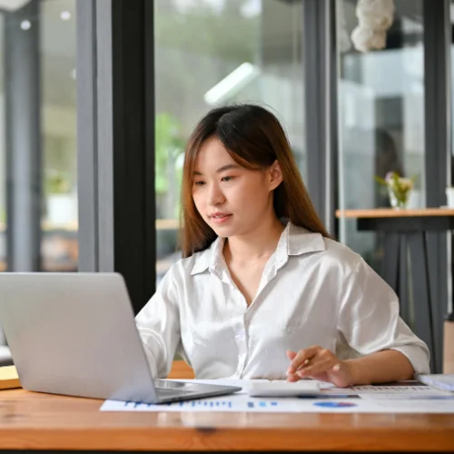 Eligibility Management Woman reviewing information on a laptop