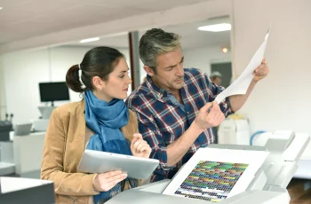 Fresh off the printer Team reviewing printed documents