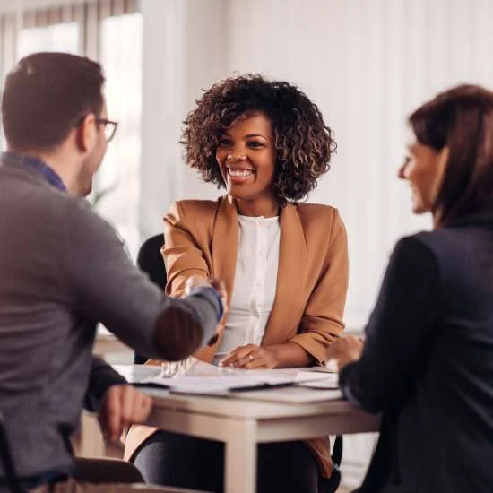 Image of an agent congratulating clients