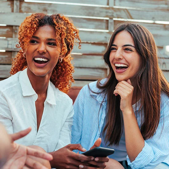 Two women enjoying a group conversation