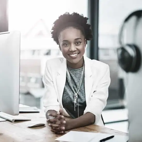 woman smiling in front of computer