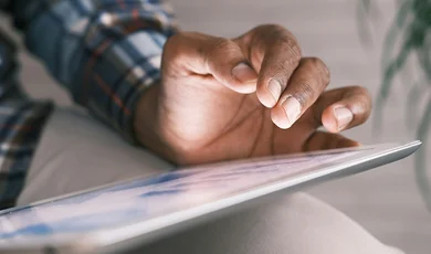 Person using tablet, close up on hand