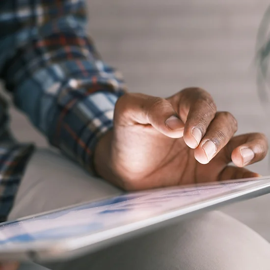 Person using tablet, close up on hand