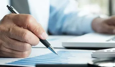Person analyzing data reports for insurance BPO services