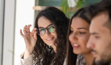 Woman adjusting glasses looking at the camera