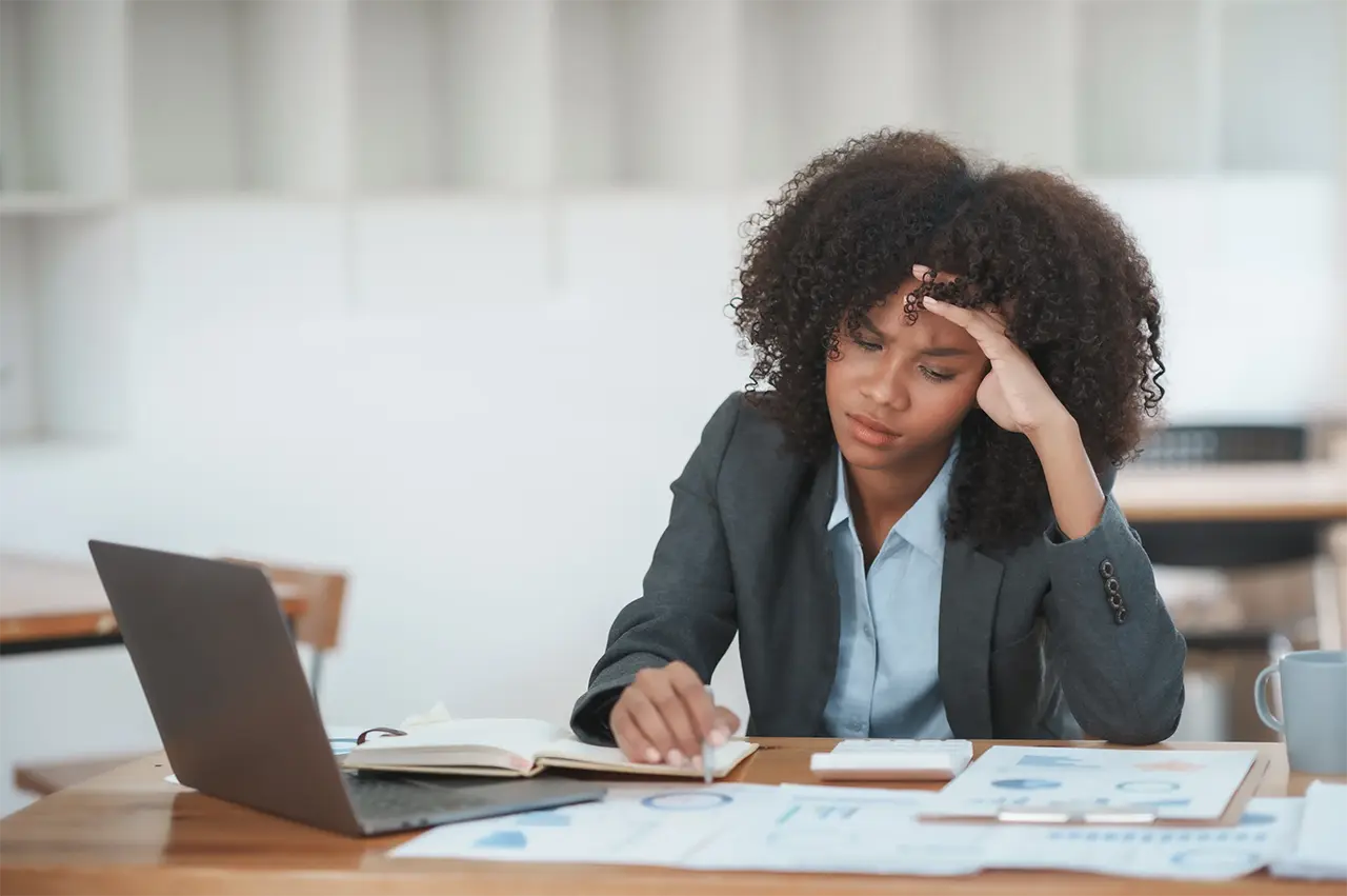 Woman at work stressing over insurance quote comparisons