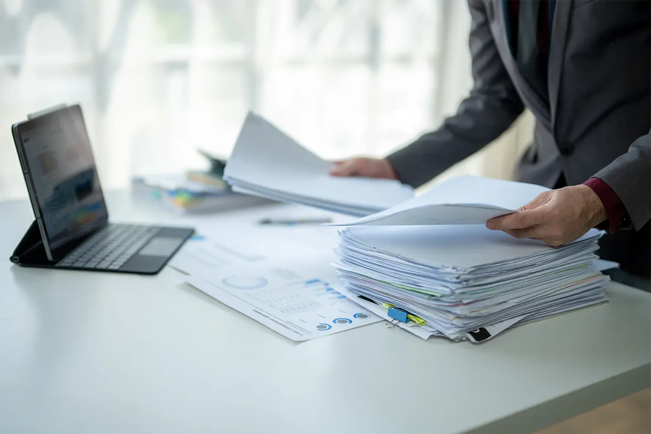 Policy Data Extract AI Businessman manually organizing a stack of reports