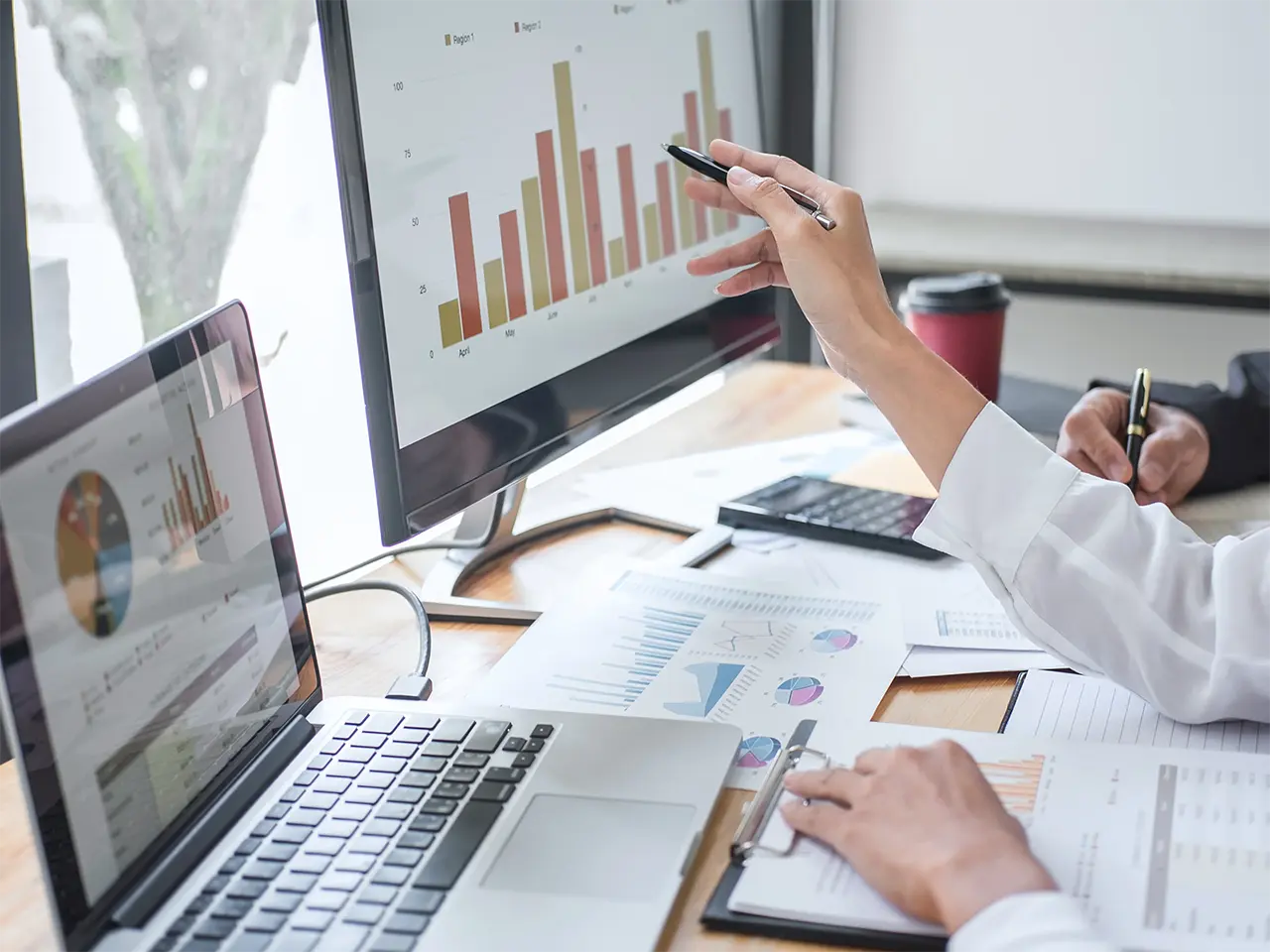 Accurate Data Extraction with Policy Data Extract AI Reviewing data on several reports using multiple computers